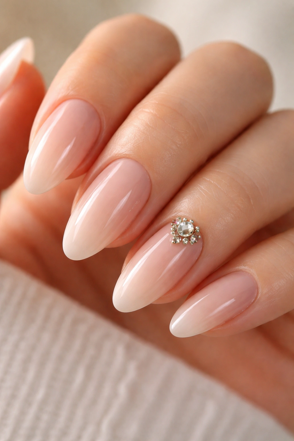 Almond nails with a small crystal cluster on the accent nail.
