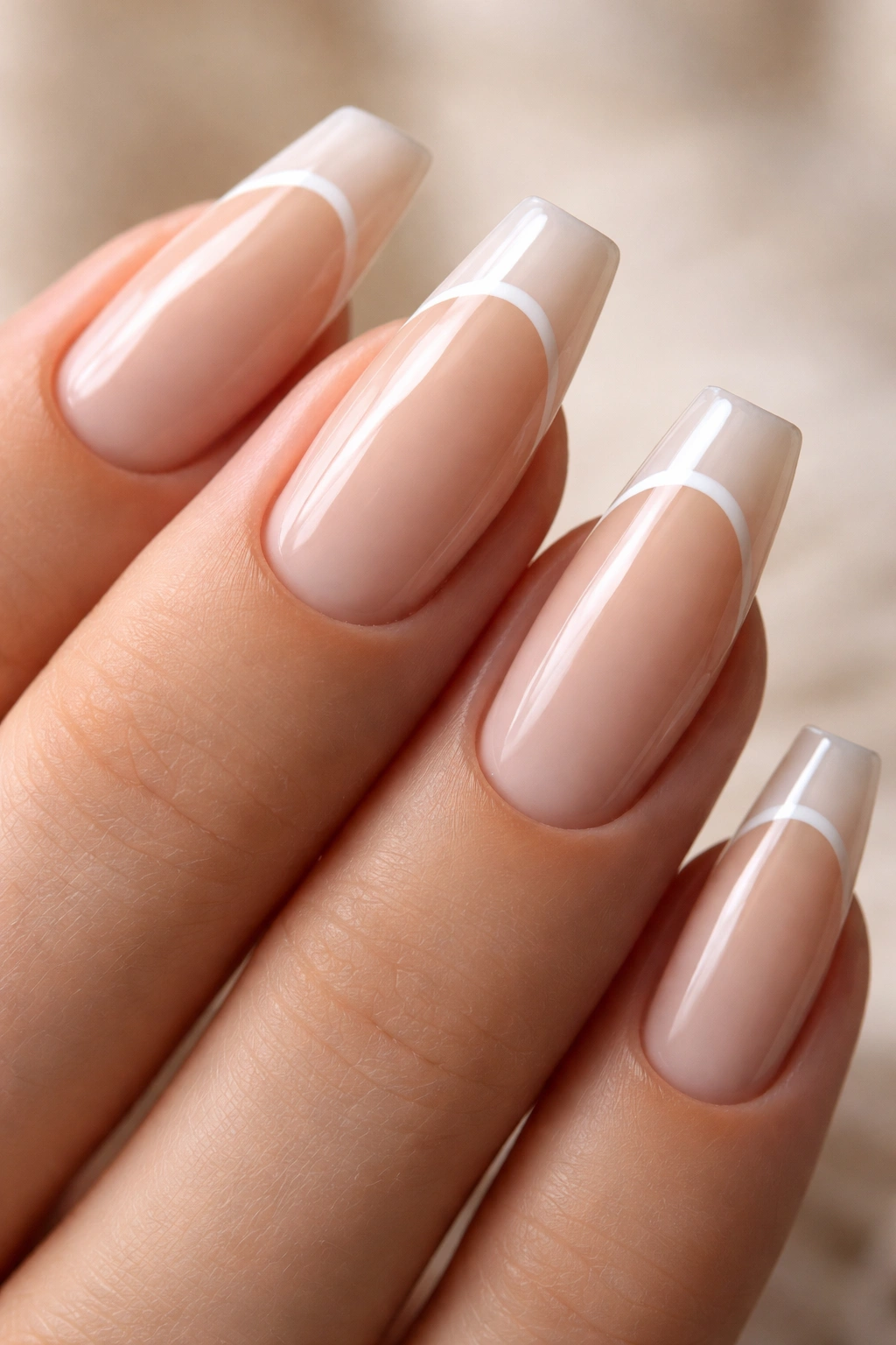 Close-up of coffin nails with tiny crescent near cuticle on sheer base