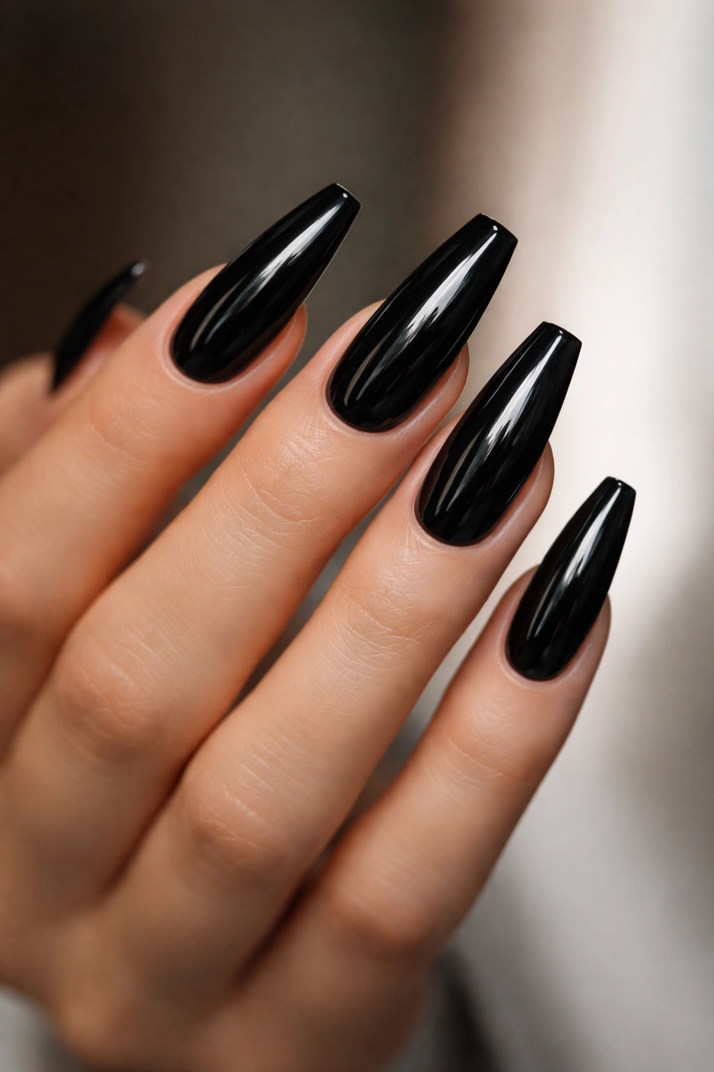 Close-up of dark coffin nails highlighting sharp silhouette and clean edges