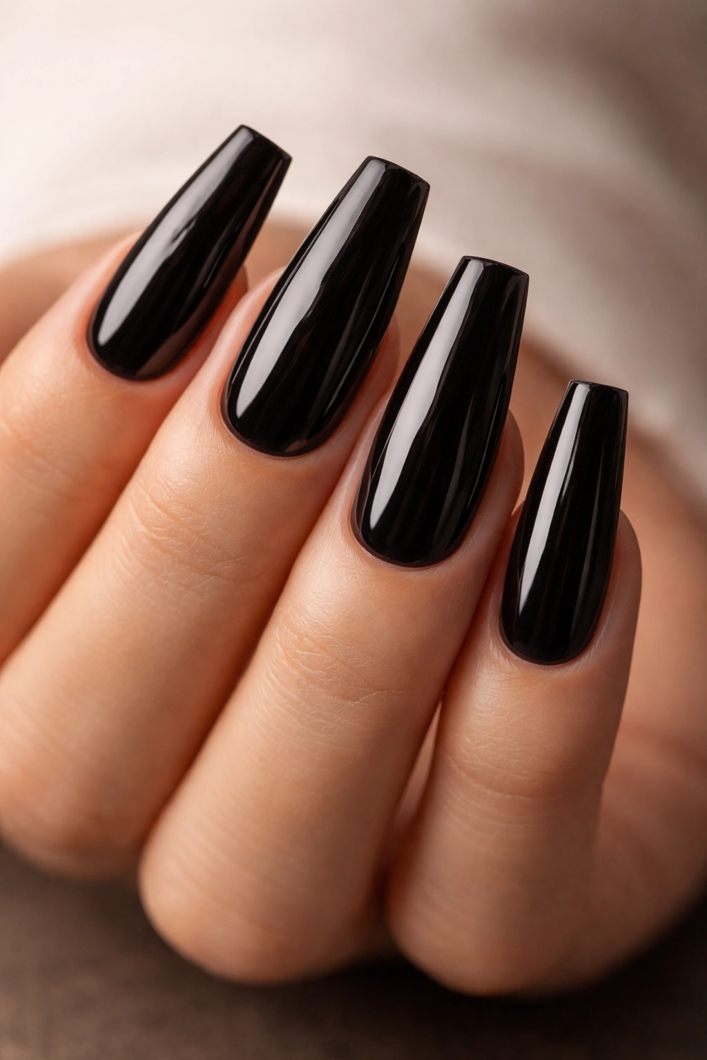 Close-up of dark coffin nails with glossy finish and clean tips