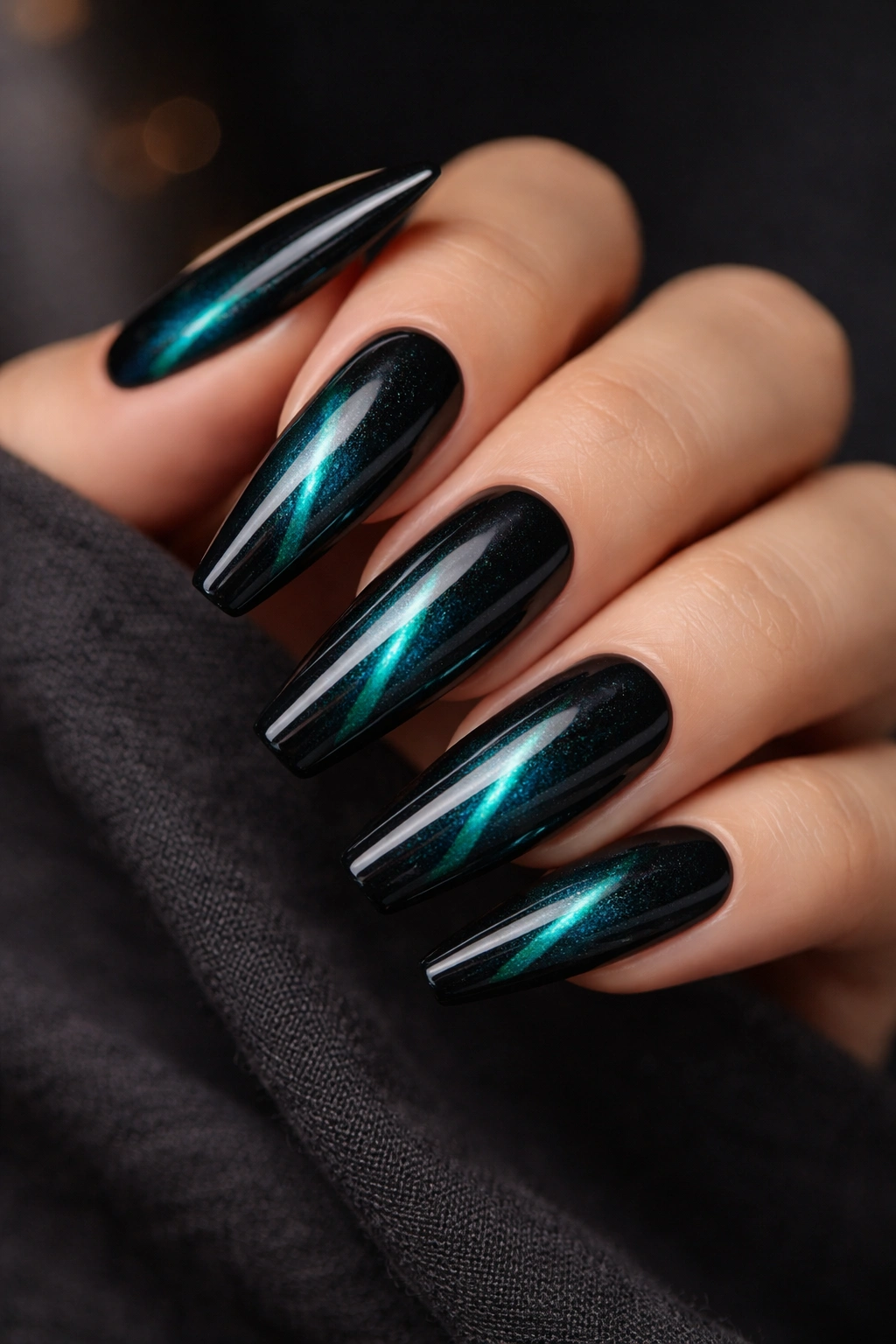Close-up of coffin nails with dark teal cat-eye shimmer line