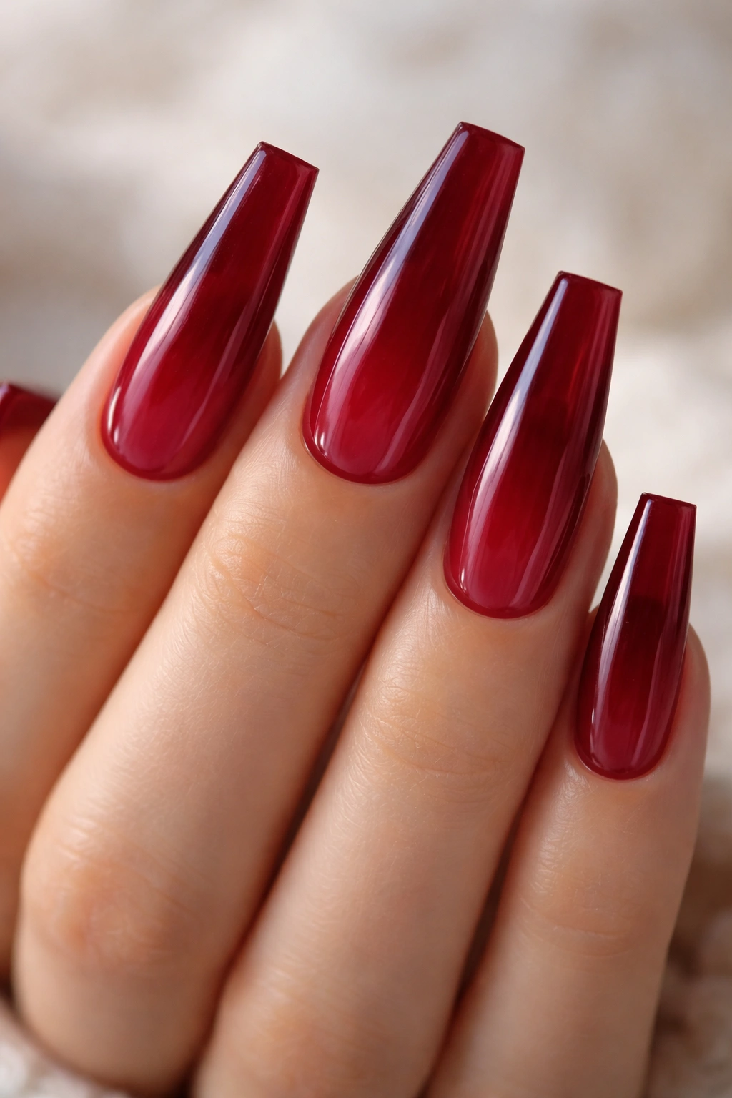 Deep cherry jelly coffin nails close-up