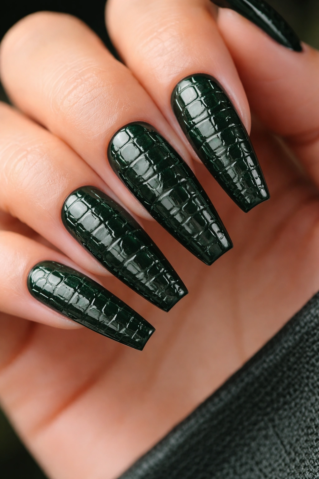 Close-up of deep green crocodile texture on coffin nails