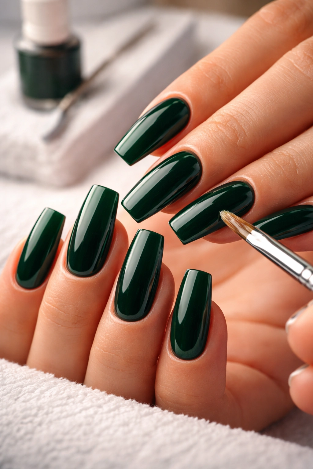 Close-up of deep green nail polish on nails with clean cuticles