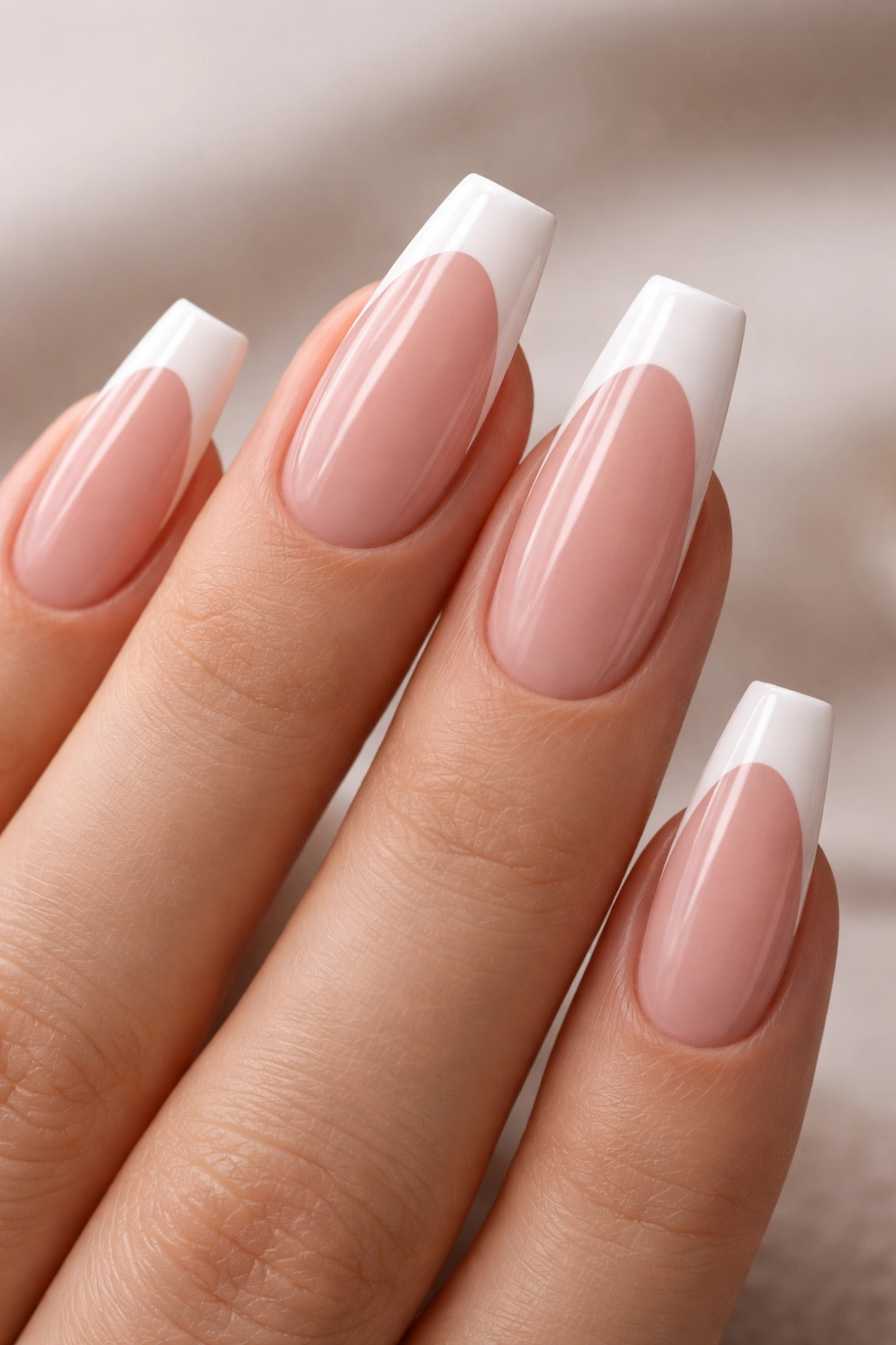 Close-up of nails with a deep curved smile line on medium coffin shape