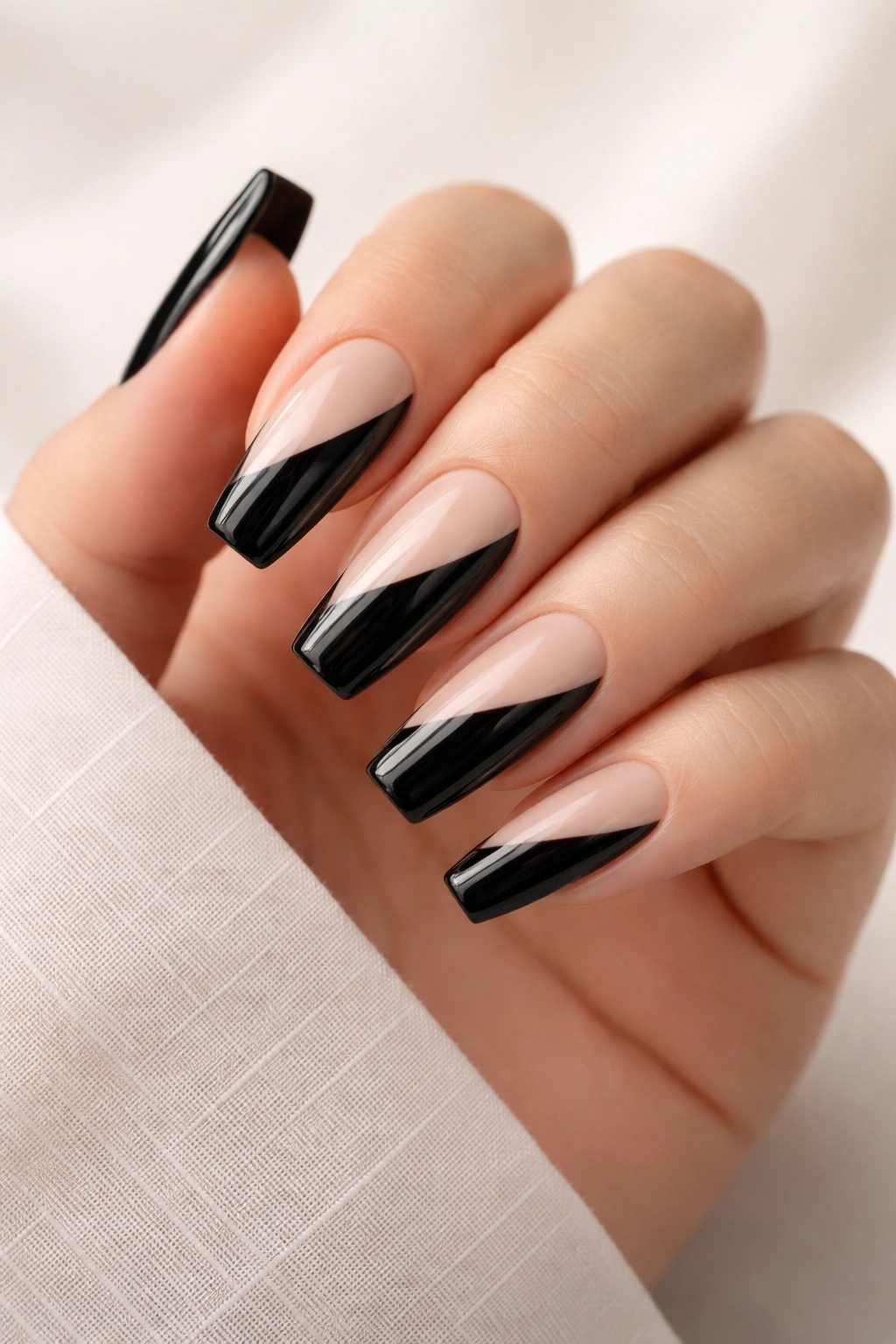 Diagonal black-and-nude coffin nails close-up