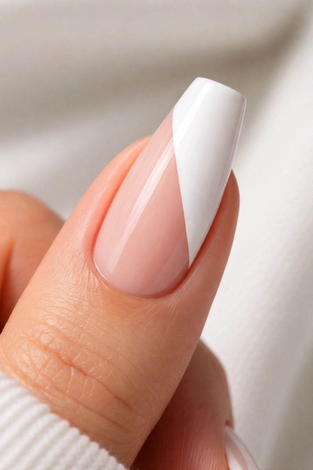 Nail with diagonal white color-block on nude base