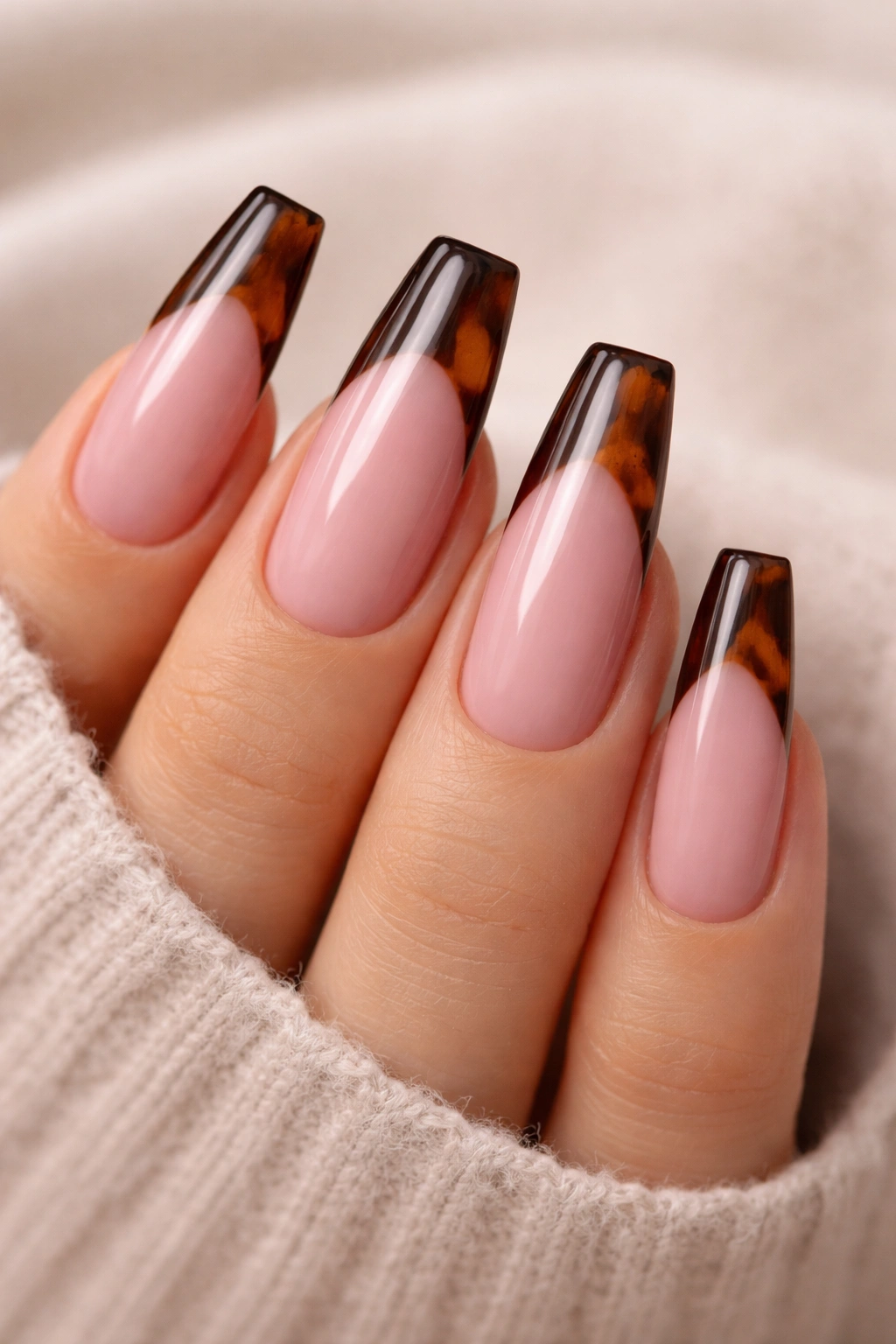 Dusty pink coffin nails with espresso tortoiseshell tips on the edge