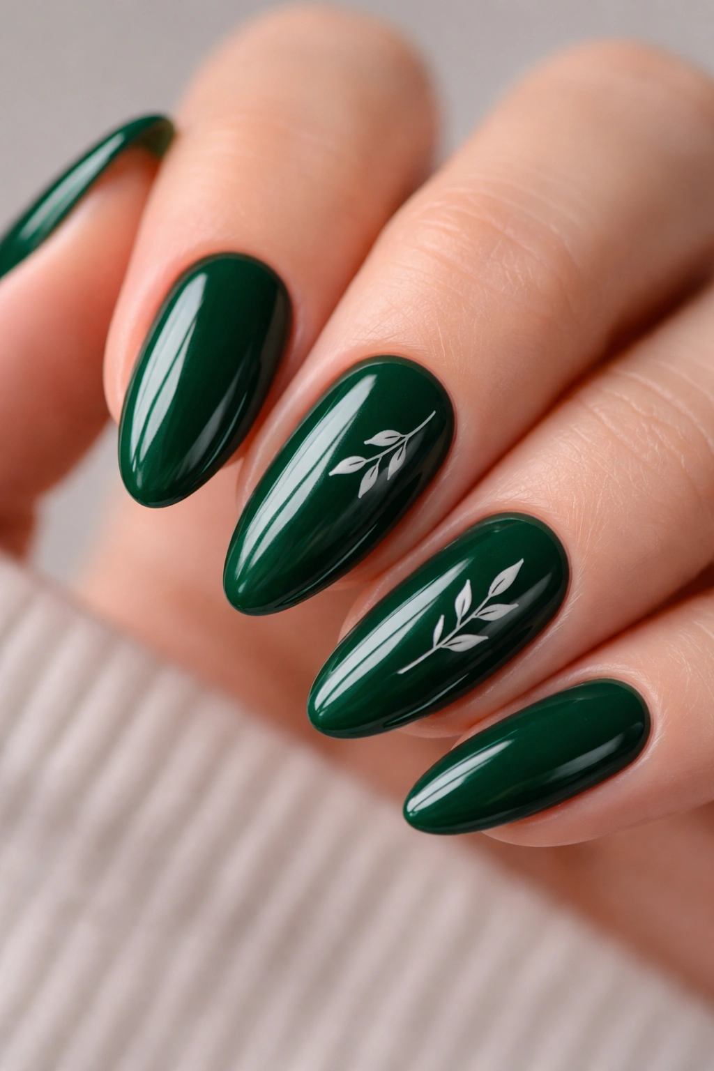 Emerald almond nails with delicate botanical line art