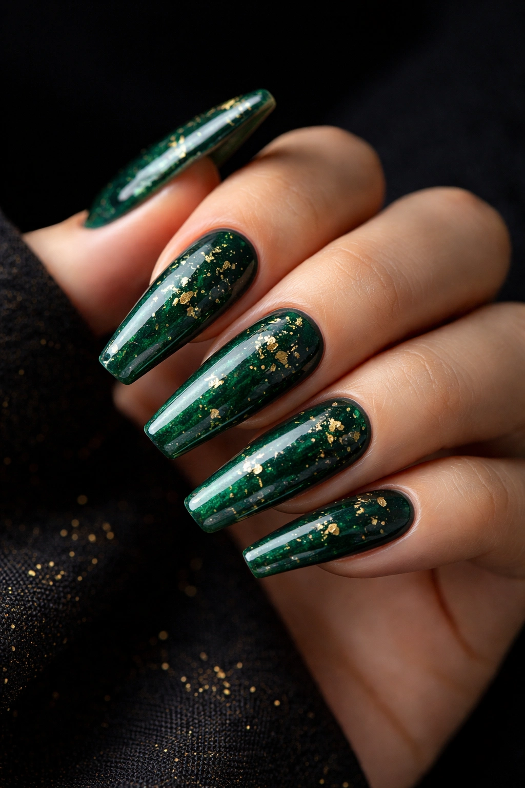 Close-up emerald green coffin nails with sparse gold flecks