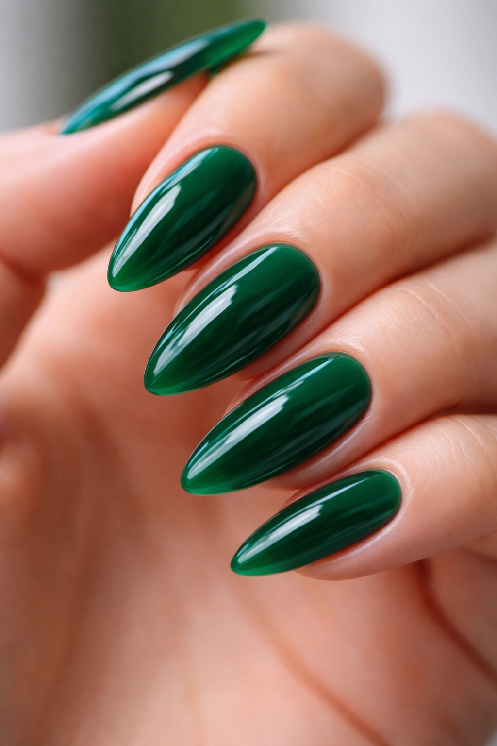 Almond nails with translucent jelly emerald polish showing depth