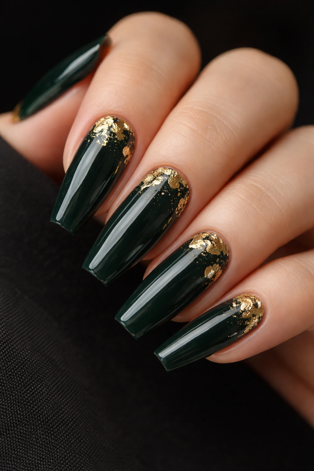 Macro close-up of forest green coffin nails with gold foil fragments