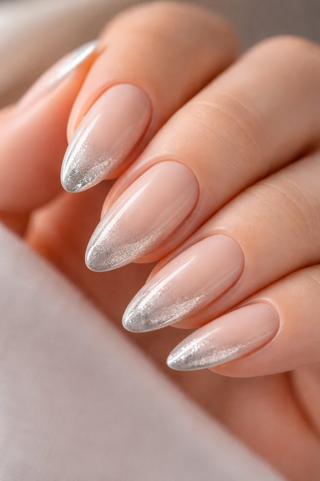 Almond nail with nude base and silver champagne French tip cat eye
