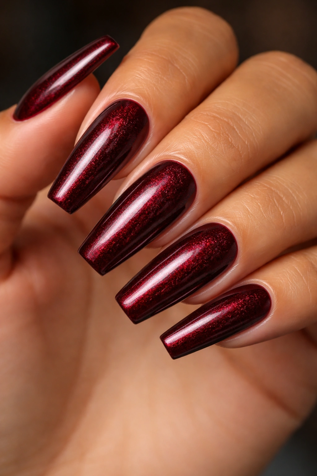 Medium-long coffin nails with garnet red shimmer.