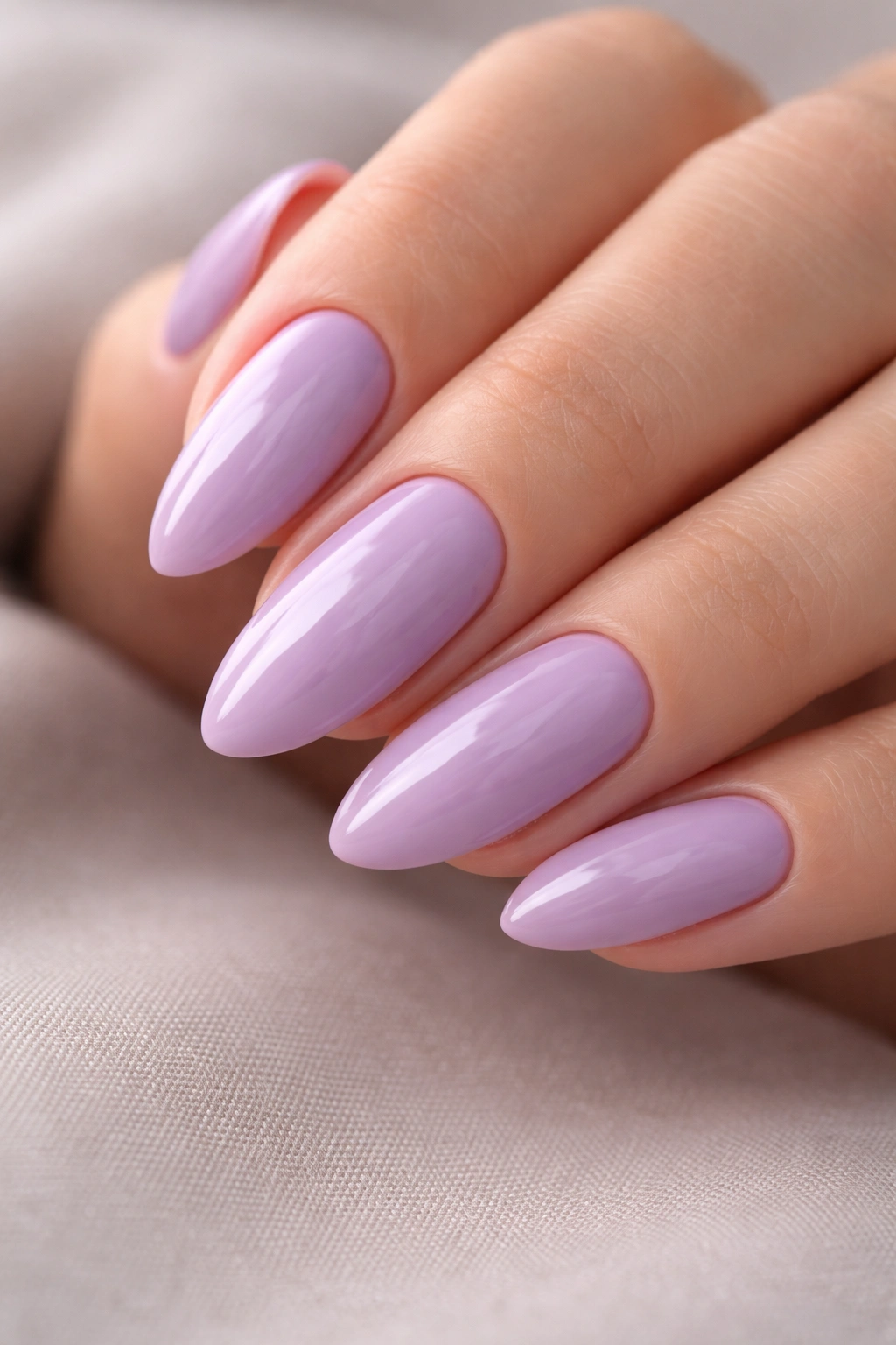 Close-up of glossy lilac almond nails with smooth edges and opaque finish