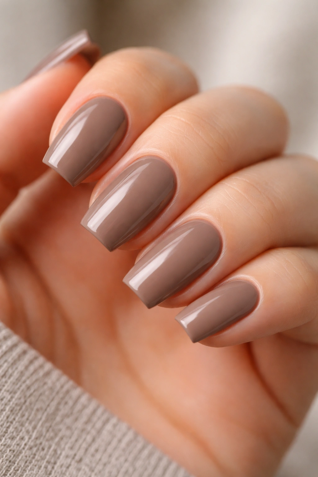 Close-up of glossy taupe coffin nails with crisp shape