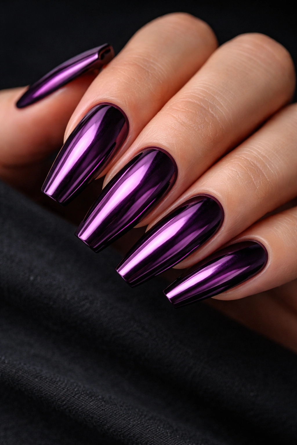Close-up of grape chrome ballerina nails with deep purple base and reflective finish