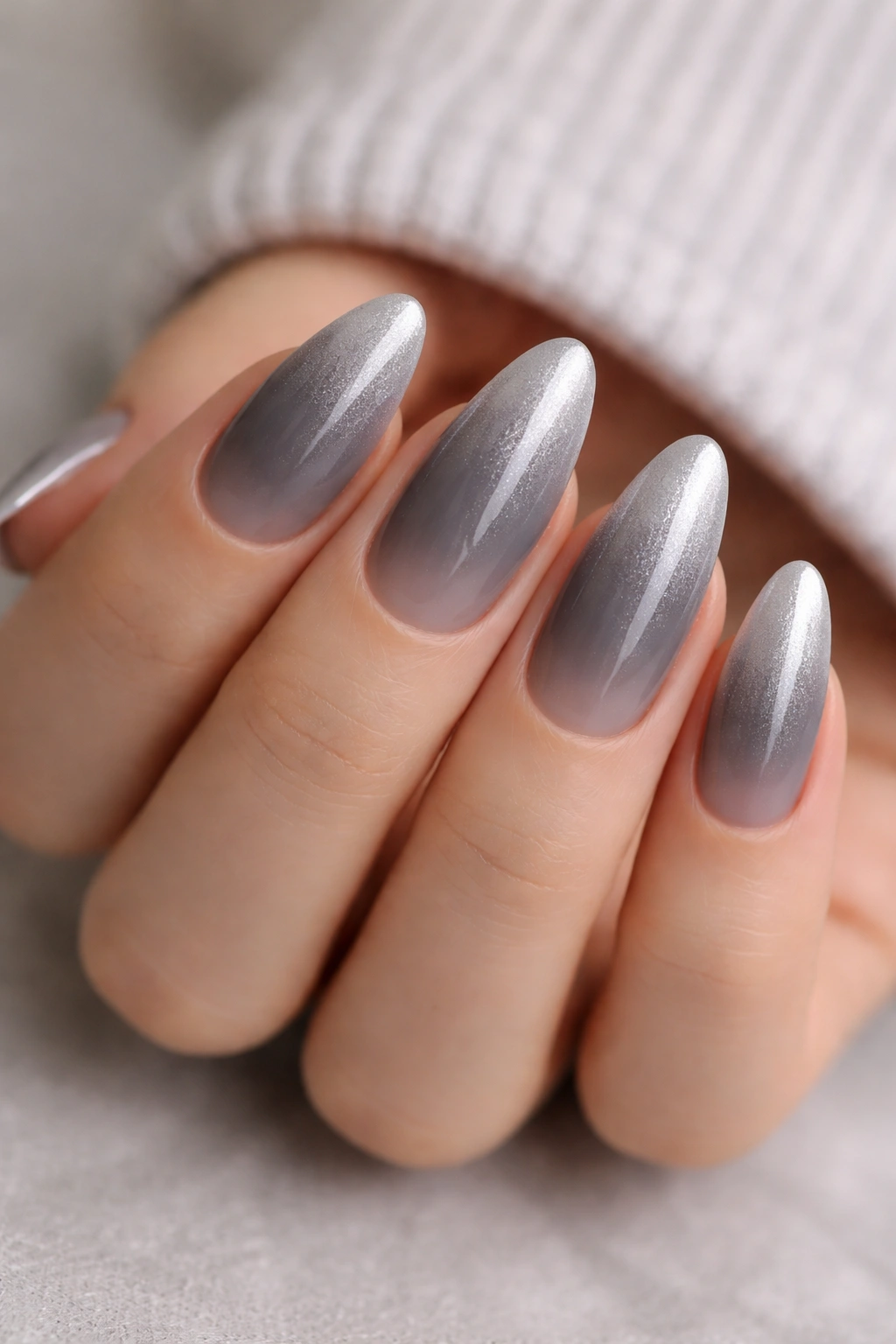 Almond nails gradient from smoky gray to silver frost with glossy finish