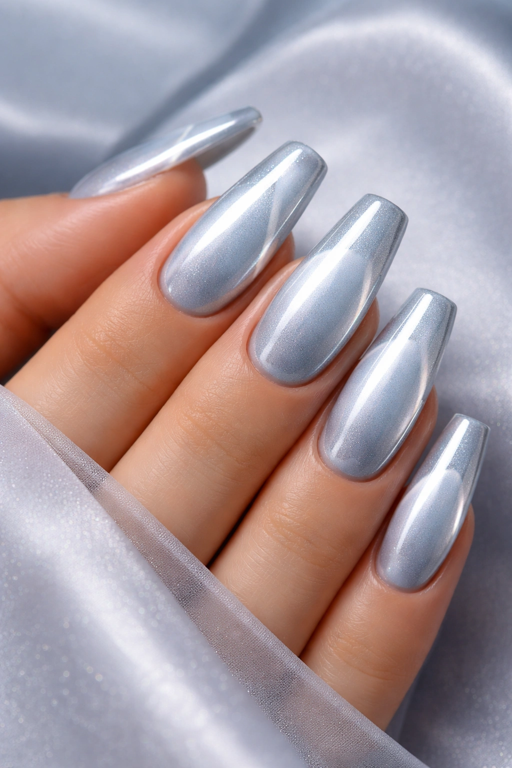 Close-up of ice blue cat eye nails with chrome halo.