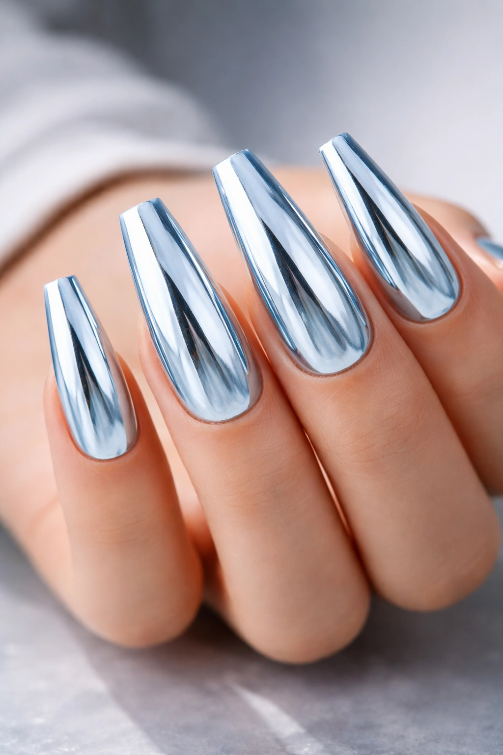 Close-up of Ice-Blue Mirror Chrome coffin nails with blue-tinted reflective finish