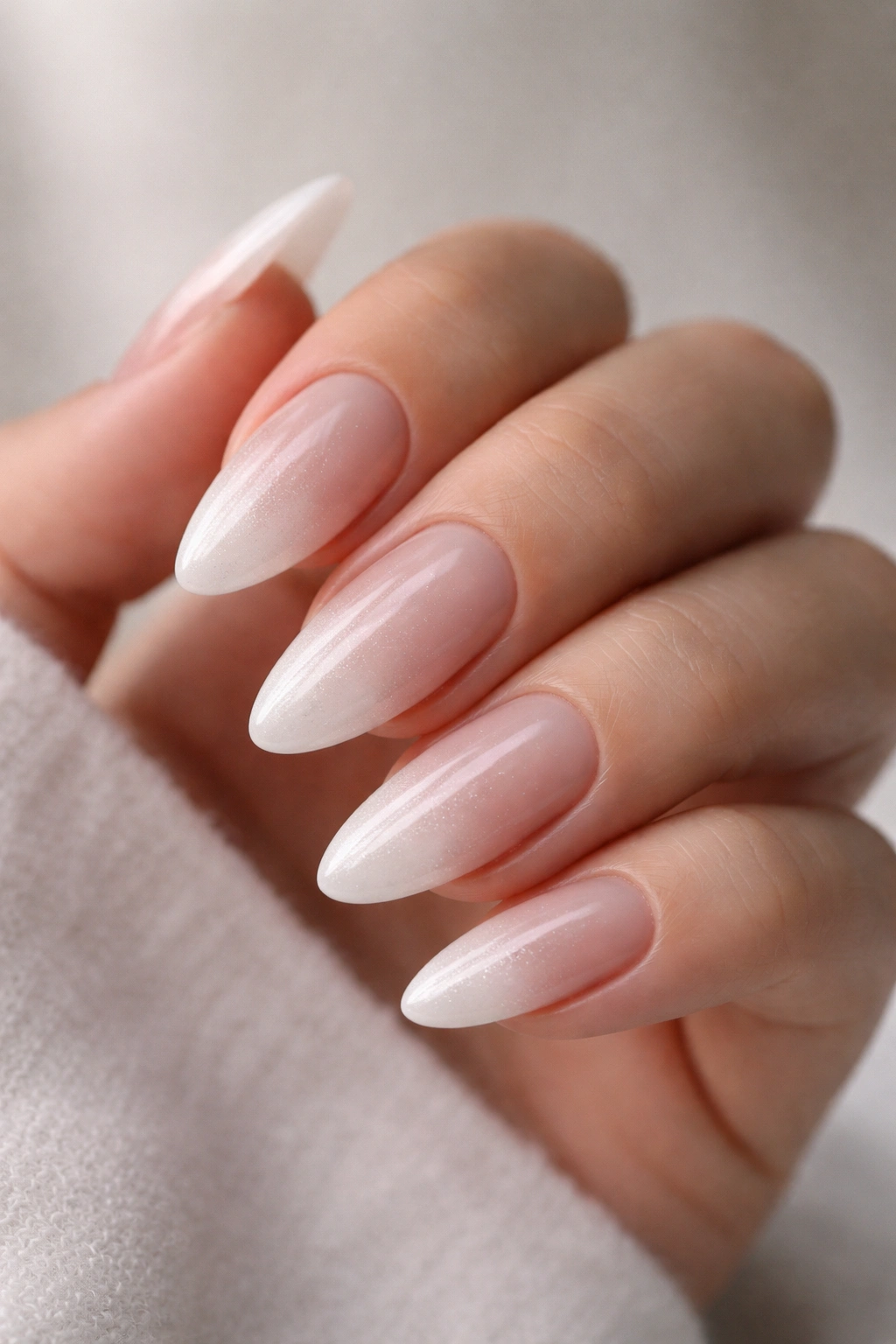 Icy nude to frosted white gradient on almond nails