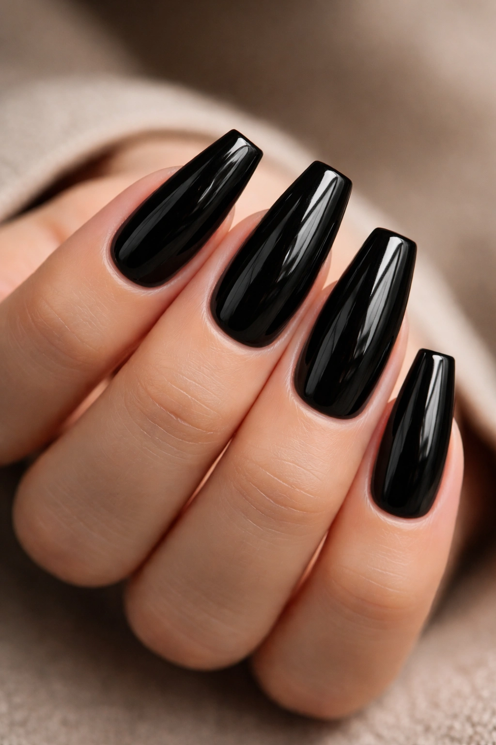 Medium-length coffin nails with glossy black patent finish and sharp edges