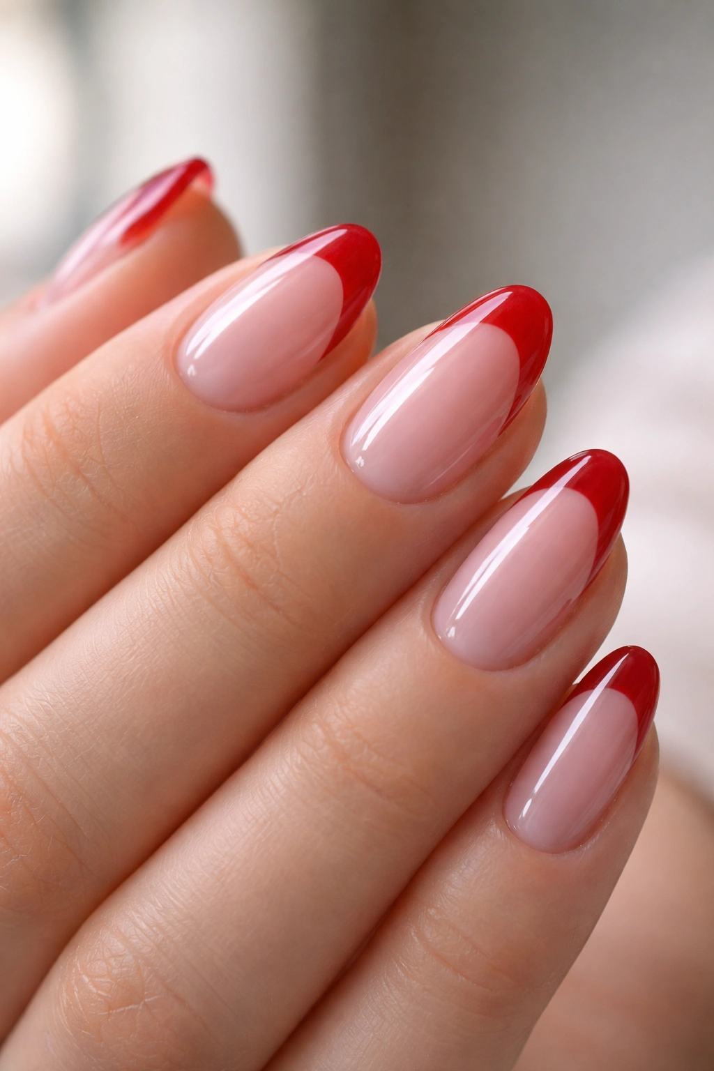 Almond nails with jelly sheer base and red tips.