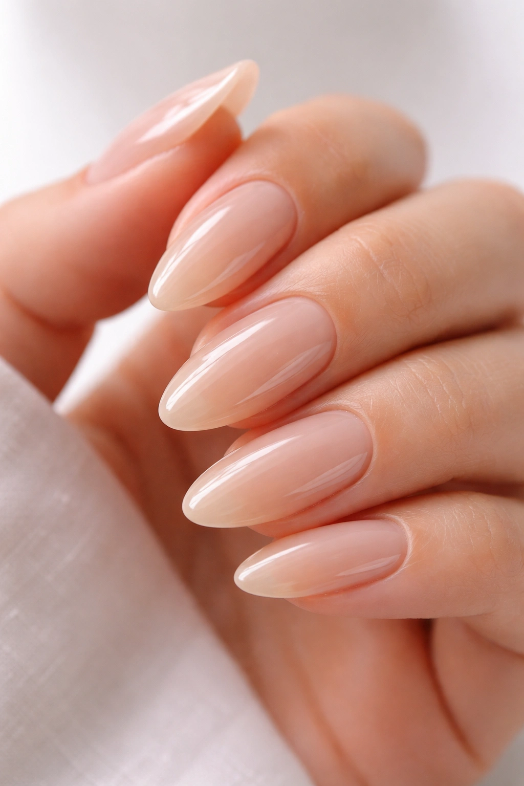 Beige translucent jelly almond nails with glossy finish