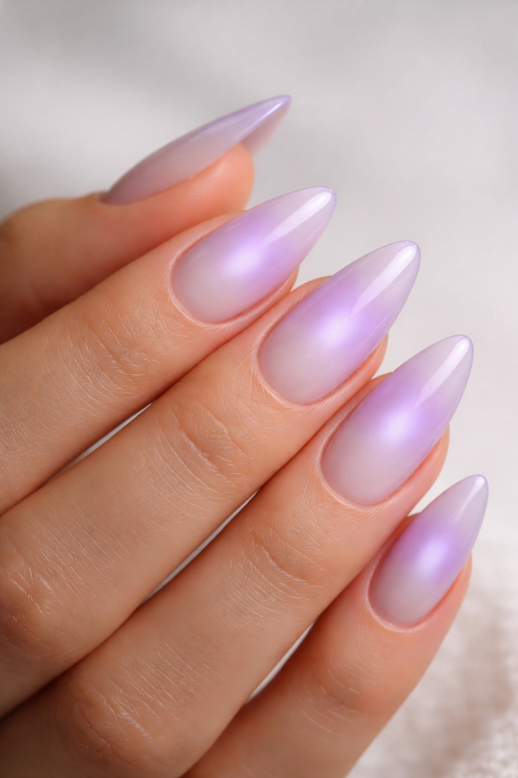 Close-up of Lavender Aura Nails on almond nails with a soft center glow and milky lavender gradient