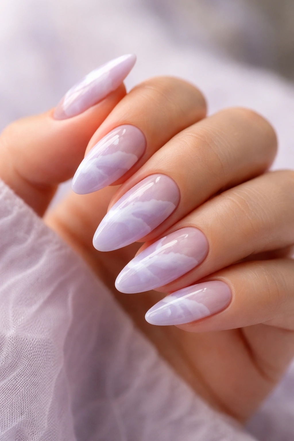 Almond nails with lavender clouds and white swirls, negative space visible