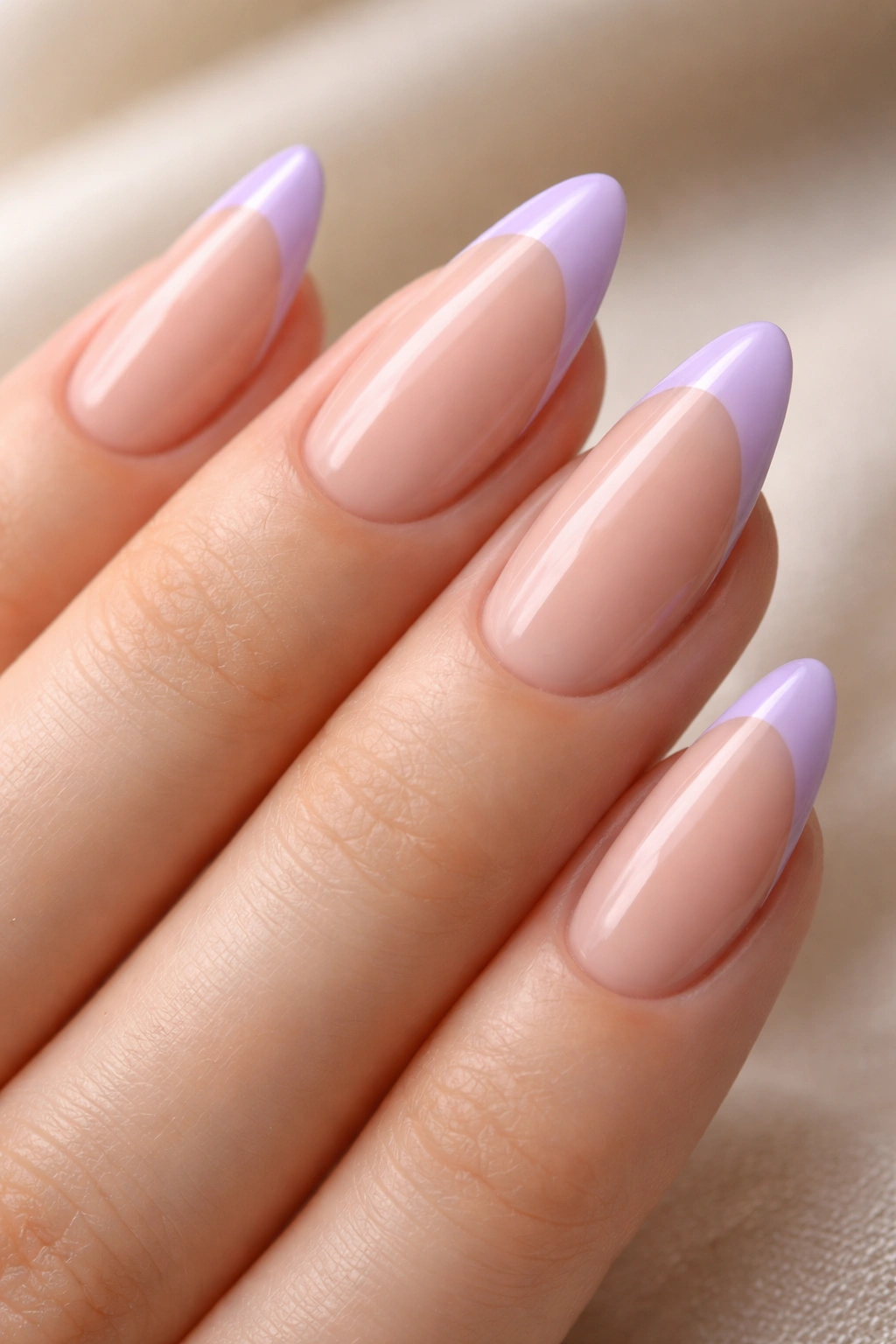 Almond nails with lavender French tips on nude base.