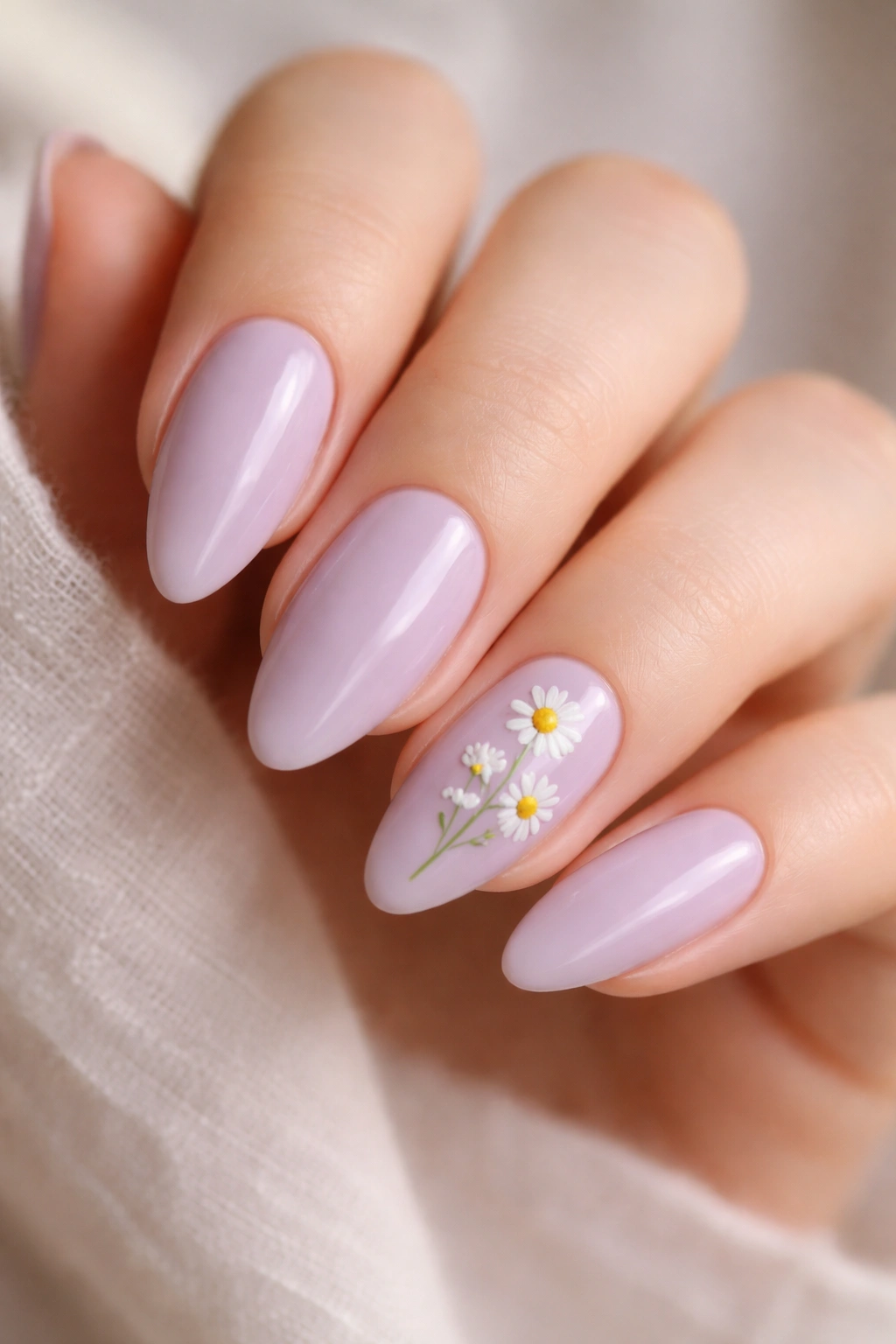 Lavender nails with tiny daisy sprigs on almond shapes