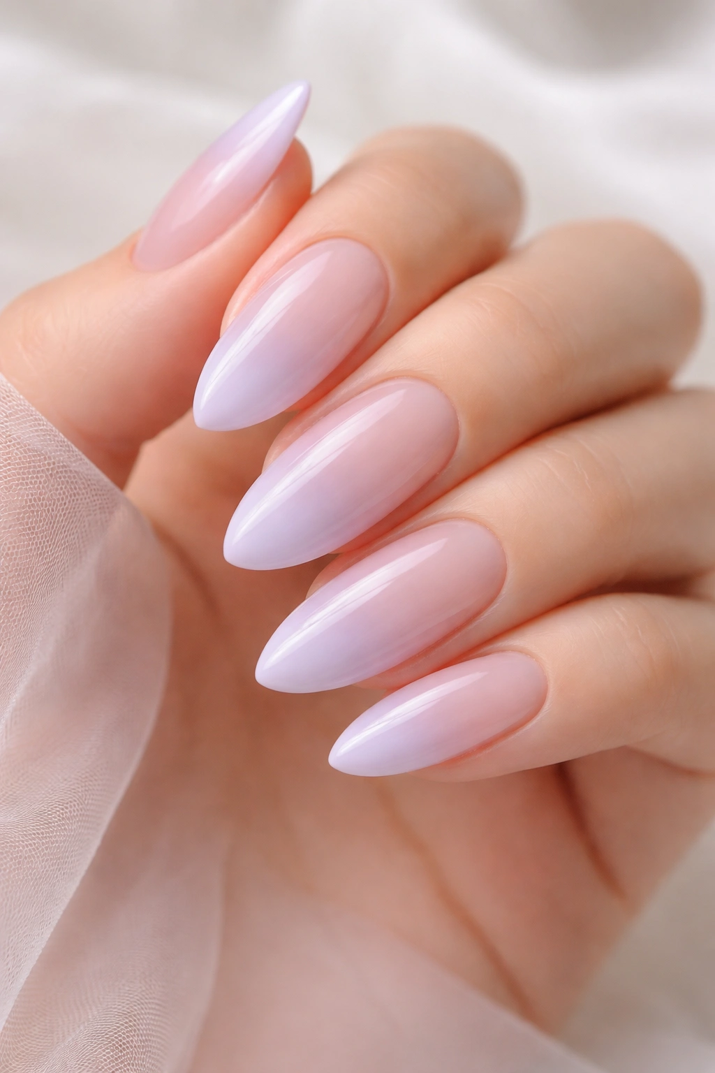 Close-up of lavender mist ombre almonds nails with glossy finish