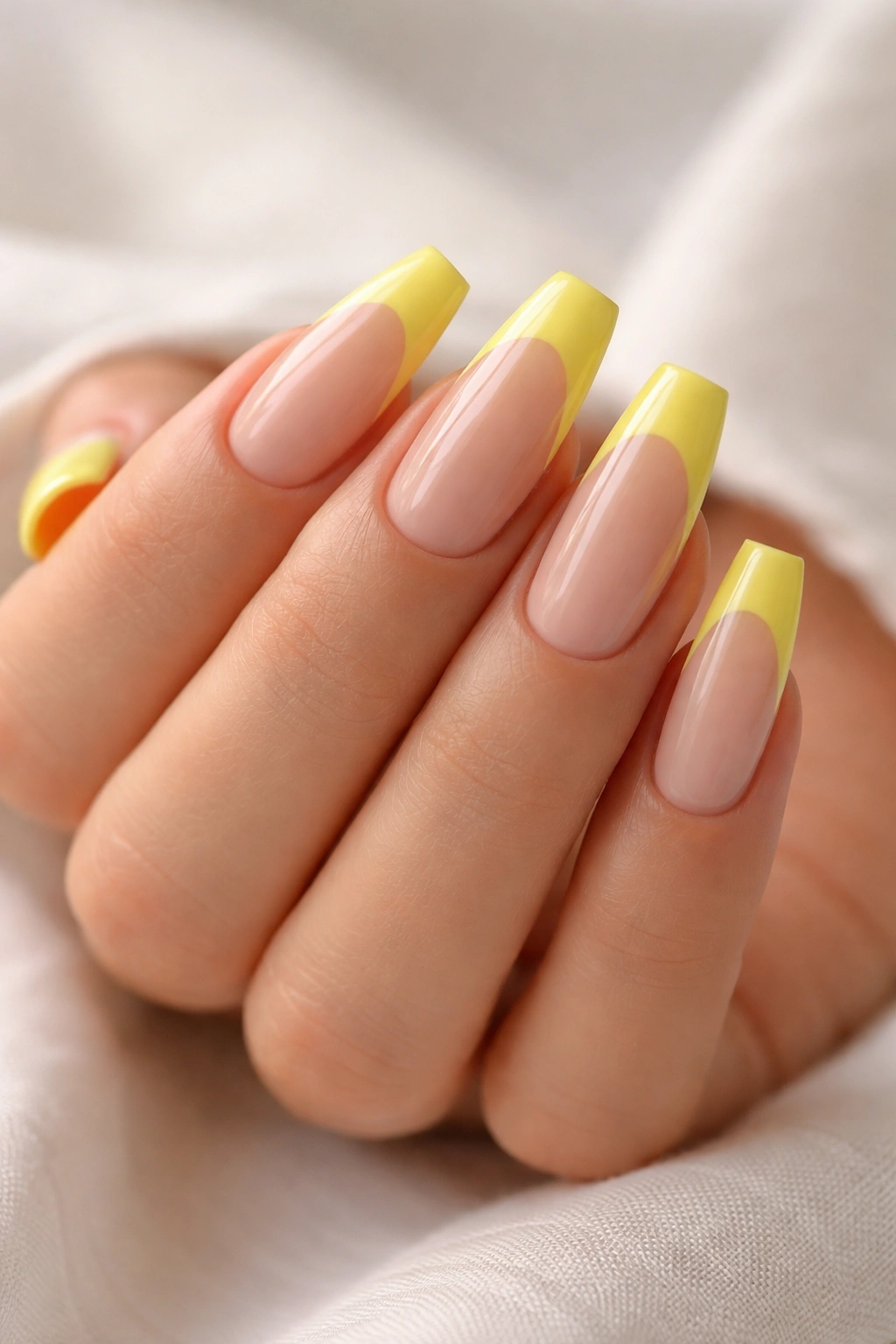 Lemon yellow coffin nails with a lemon tip on nude base