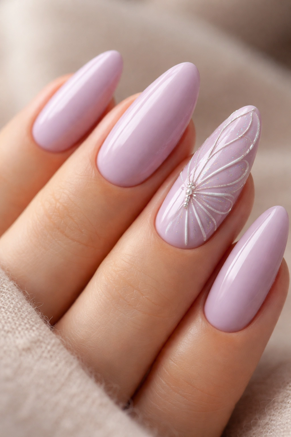 Almond nails with lilac base and butterfly wing 3D detailing on accent nails