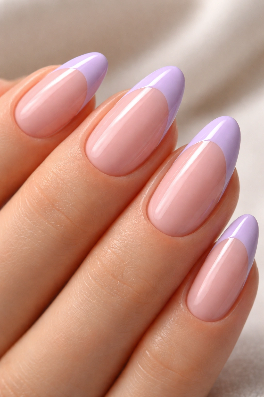 Almond nails with lilac French tips on a sheer pink base