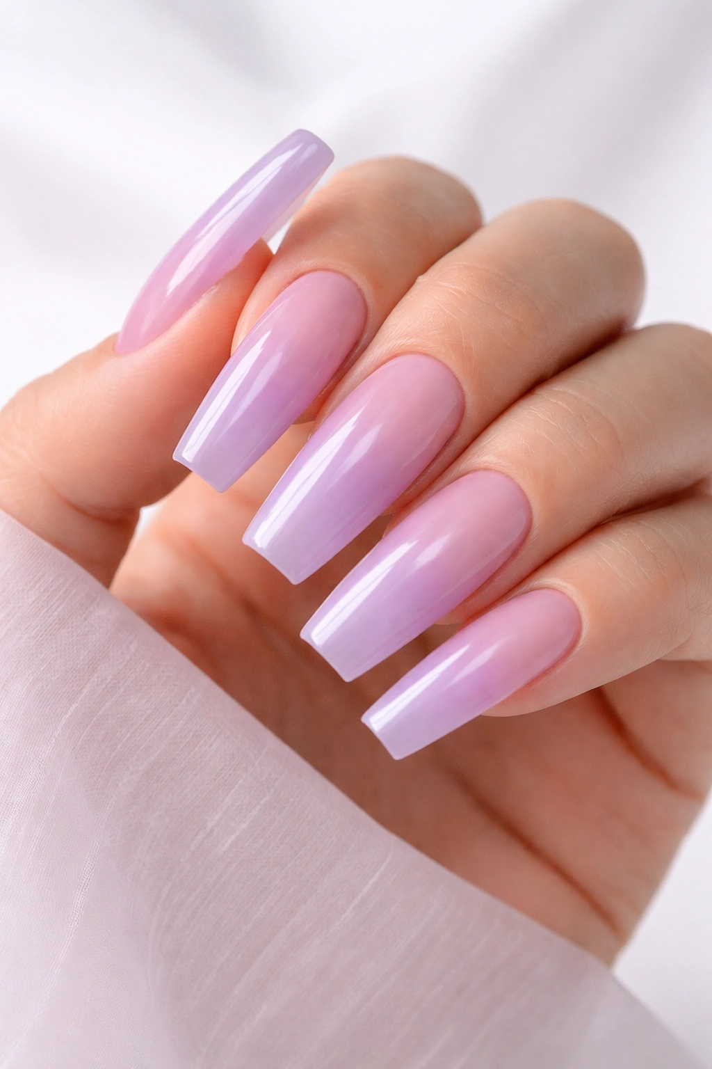 Close-up of lilac to icy lavender coffin nails with translucent jelly base