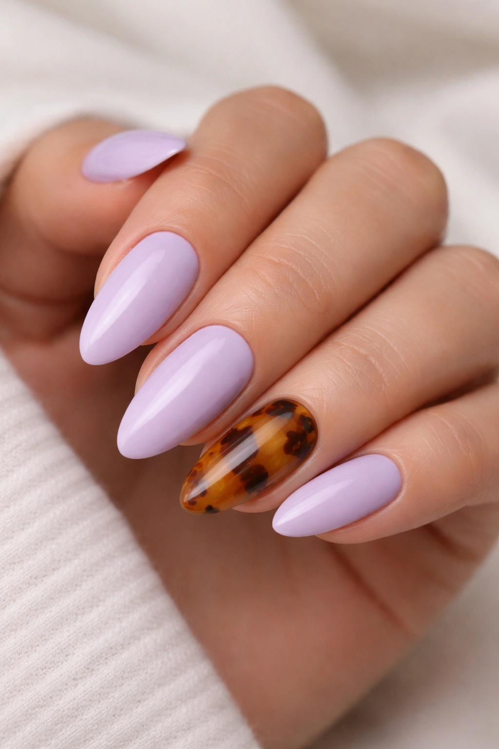Lilac almond nails with tortoiseshell accent on one nail