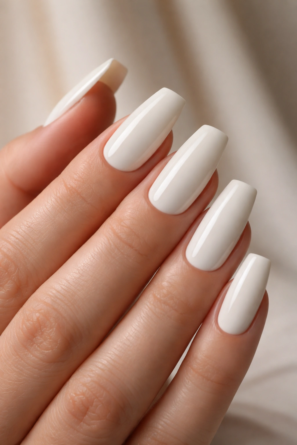 Close-up of coffin nails in soft linen white with glossy finish