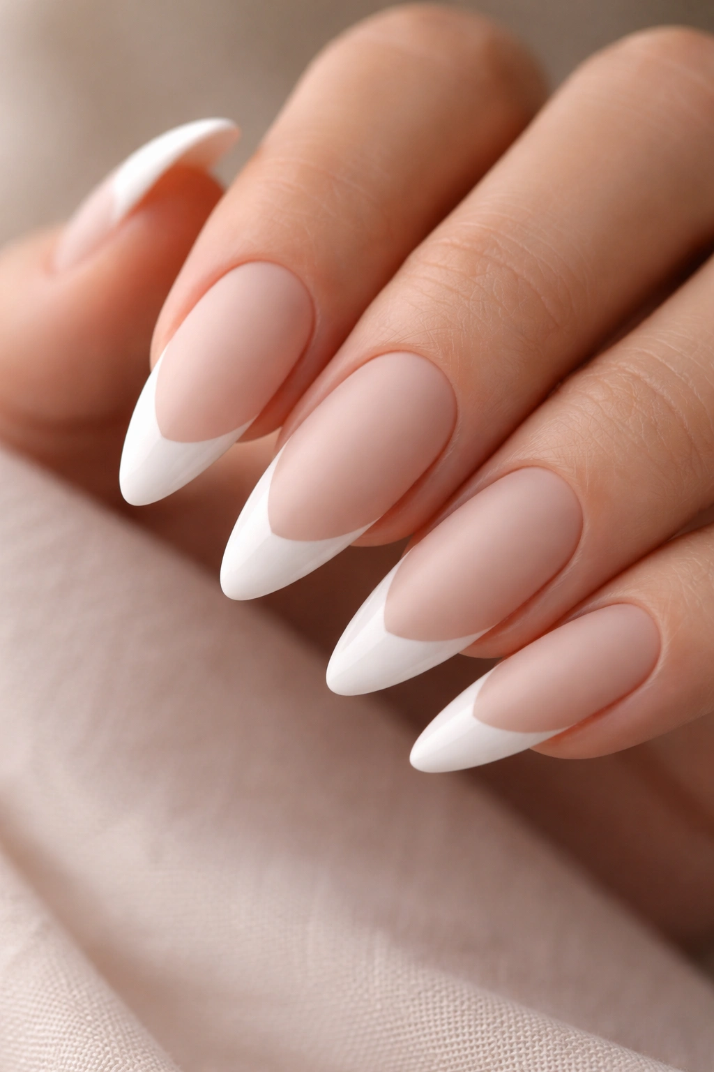 Close-up of long almond nails with matte base and glossy tips