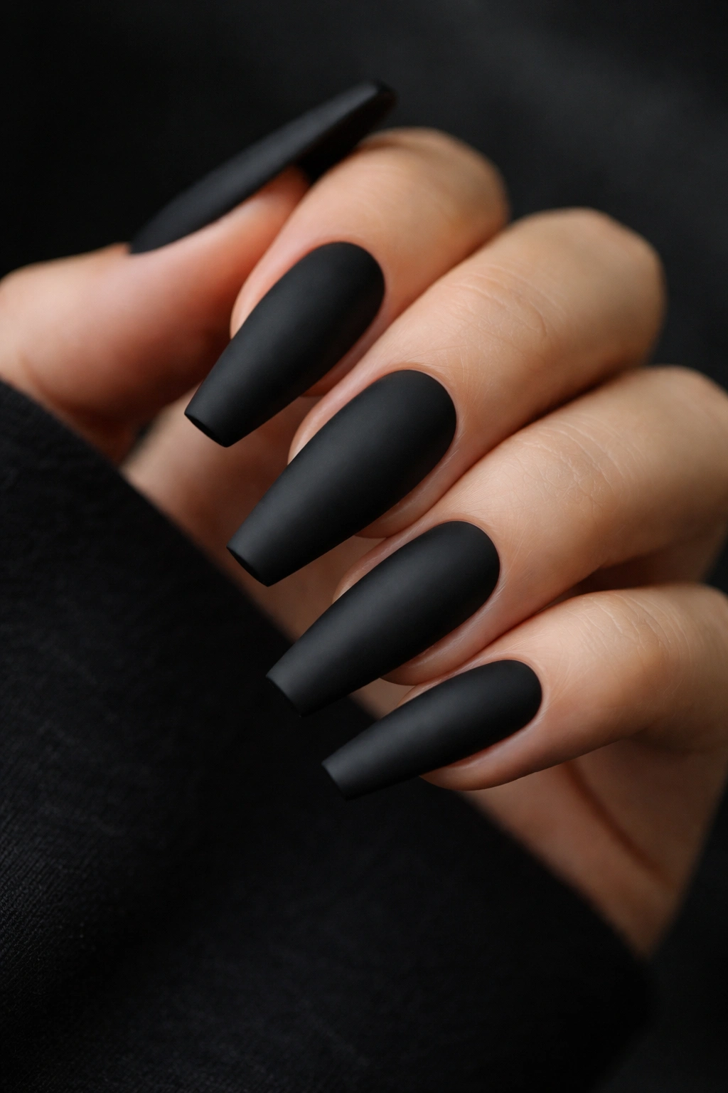 Close-up of matte black coffin nails with crisp edges