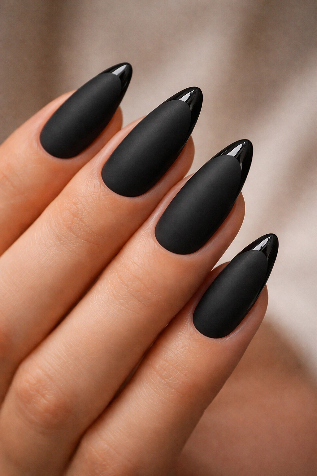 Almond nails with matte black base and glossy tip line