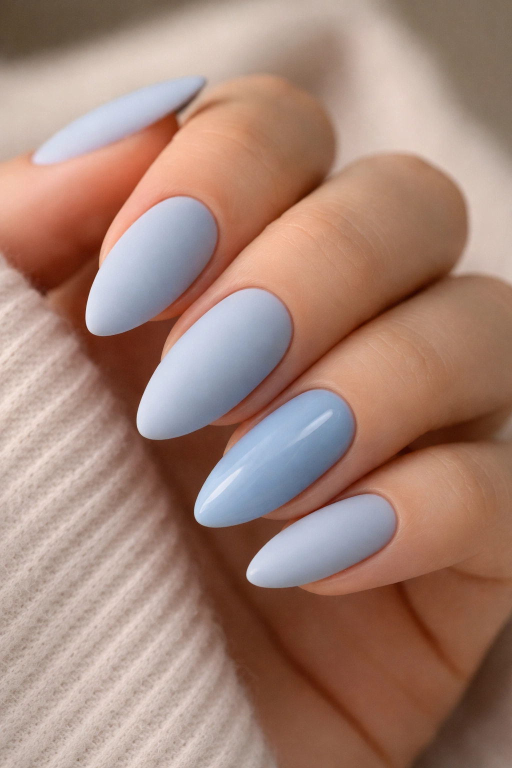 Matte blue almond nails with one glossy accent