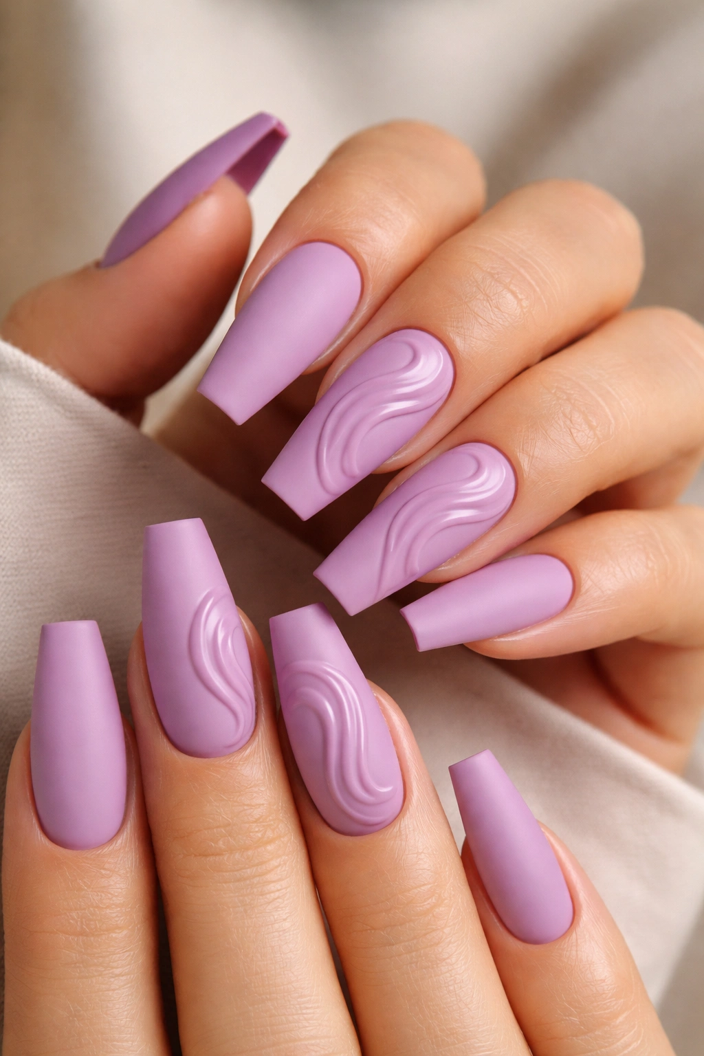 Matte orchid nails with glossy raised white swirls