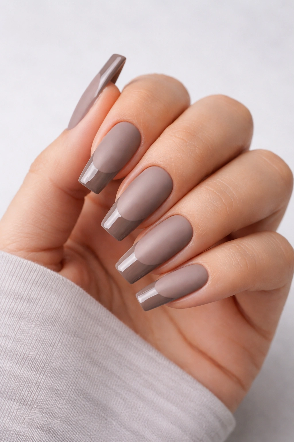 Close-up of matte taupe coffin nails with glossy tips