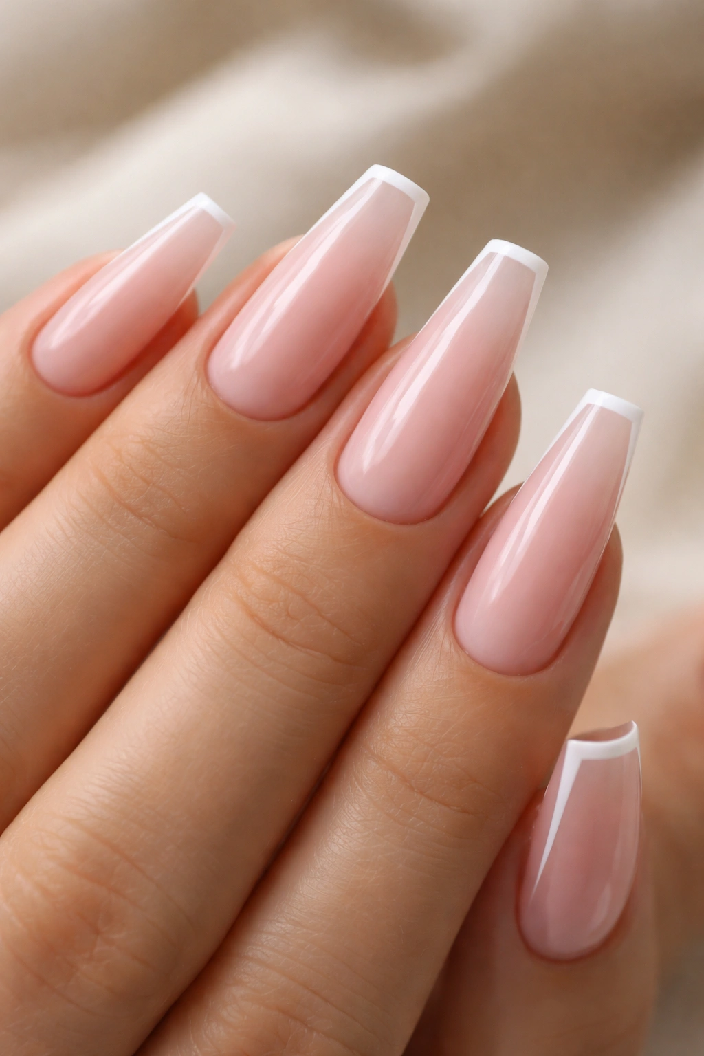 Soft pink micro French coffin nails close-up