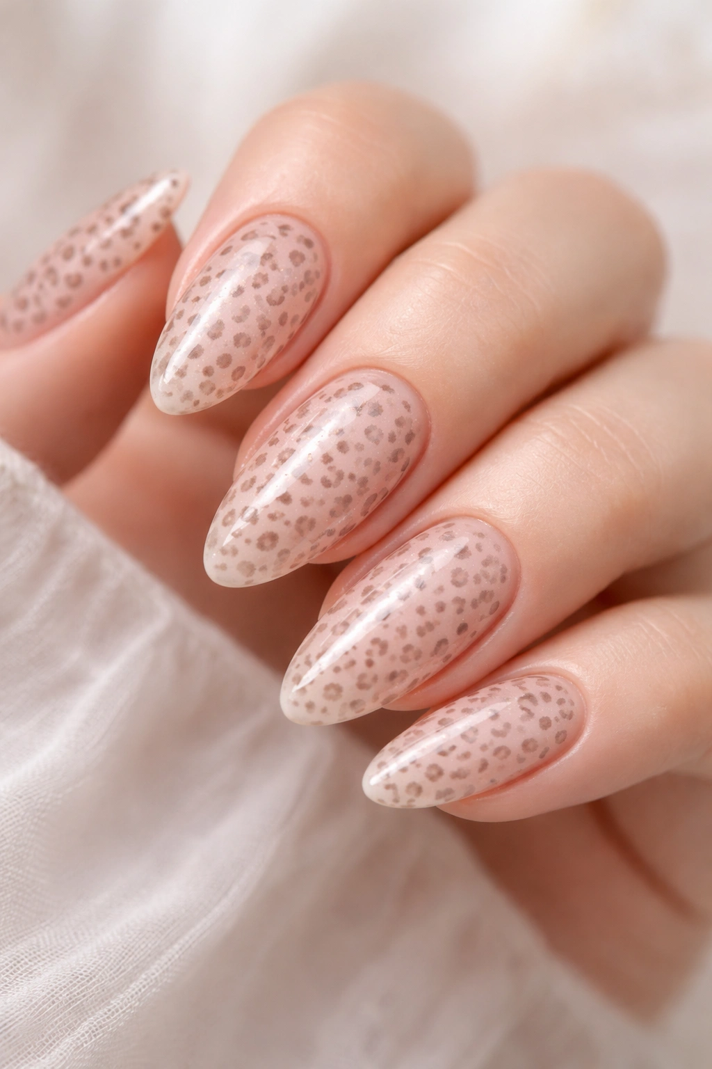Almond nails with micro leopard print on sheer pink base