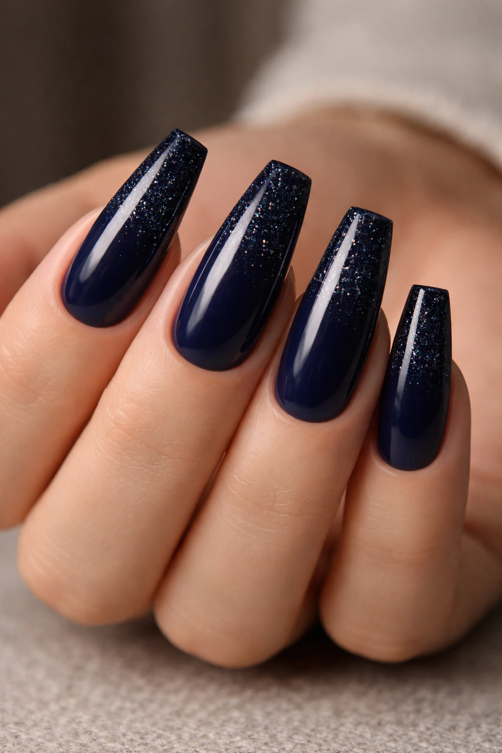 Midnight blue glitter fade coffin nails with tip-dense glitter fading toward base