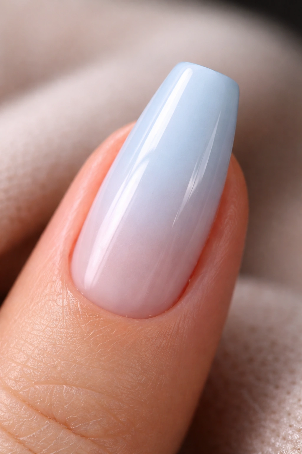 Milky blue coffin nail with a sheer glossy finish.