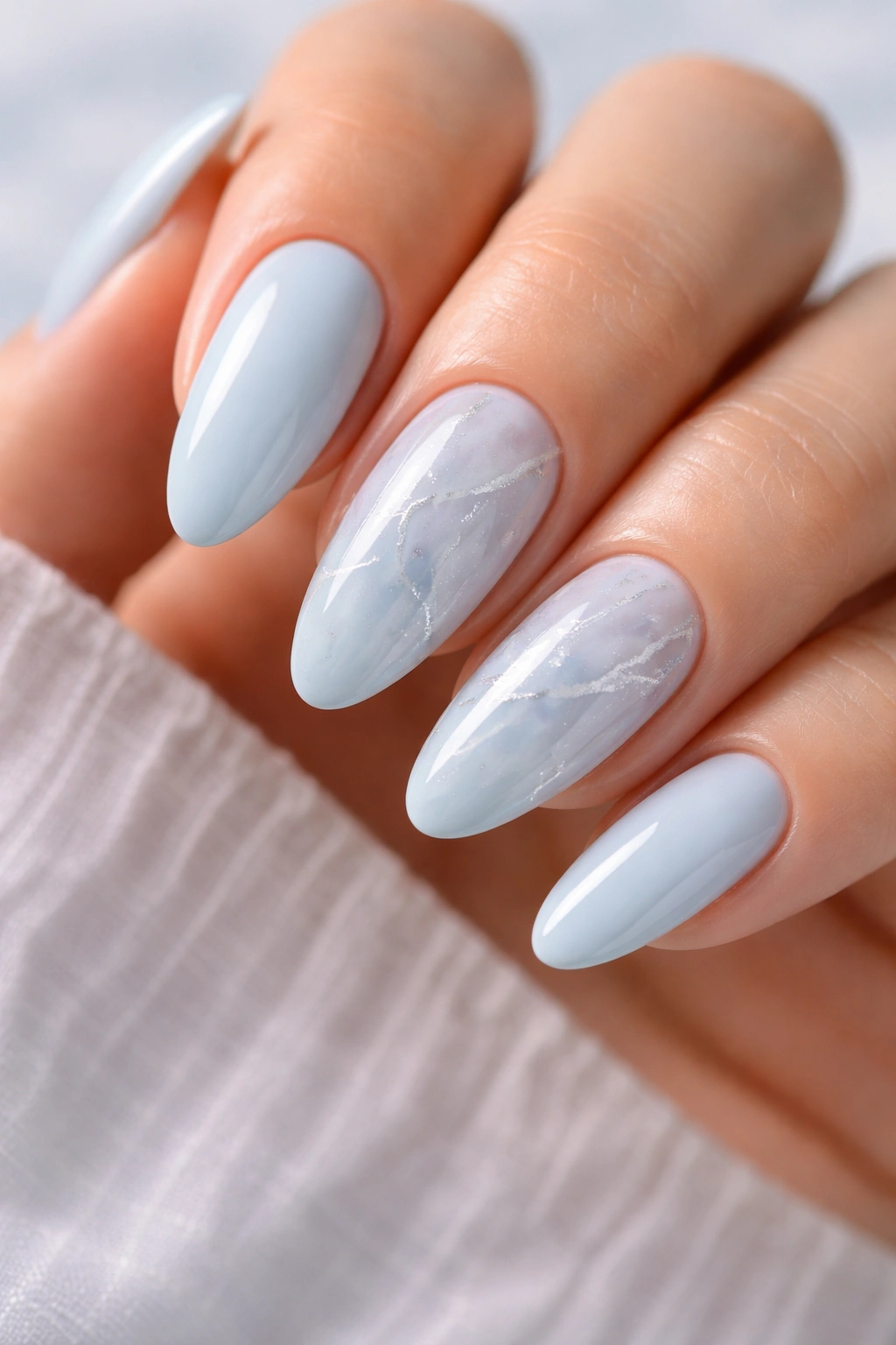 Almond nails with milky blue marble and white veining